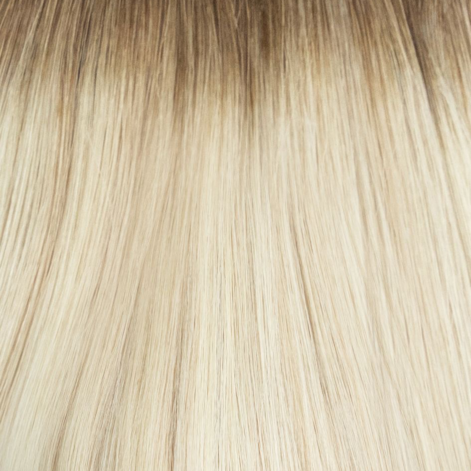 Close-up of blonde hair strands with a gradient from light to dark.
